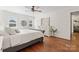 Bright main bedroom features a ceiling fan, a dresser, and wood floors at 1226 Flint Ct, Matthews, NC 28104