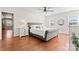 Bright main bedroom features a ceiling fan, ensuite bath, and wood floors at 1226 Flint Ct, Matthews, NC 28104