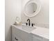 Stylish powder room with a farmhouse sink, matte black faucet and an elegant round mirror at 1226 Flint Ct, Matthews, NC 28104
