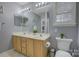 Bathroom featuring a double vanity, light wood cabinets, neutral colored walls, and large mirror at 12928 Sickles Dr, Charlotte, NC 28273