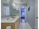 Bathroom vanity with double sinks and a view into the bedroom at 12928 Sickles Dr, Charlotte, NC 28273