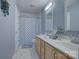 Bathroom with double sinks, a large mirror, and a shower/tub with a decorative curtain at 12928 Sickles Dr, Charlotte, NC 28273