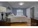 Bright bedroom with a window, a bed and coordinating dresser and night stand at 12928 Sickles Dr, Charlotte, NC 28273