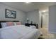 Bedroom featuring neutral walls, carpeted floors, and a black dresser with clock and lamp at 12928 Sickles Dr, Charlotte, NC 28273