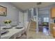 Dining area with gray walls, view of stairs to second floor, and living room at 12928 Sickles Dr, Charlotte, NC 28273