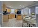 Kitchen featuring light wood cabinets, gray walls, tile floors, and dining area at 12928 Sickles Dr, Charlotte, NC 28273