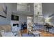 Open-concept living room featuring a fireplace, hardwood floors, staircase, and view of the dining area at 12928 Sickles Dr, Charlotte, NC 28273