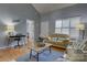 Inviting living room with high ceilings, neutral tones, wood flooring, and cozy seating arrangement at 12928 Sickles Dr, Charlotte, NC 28273