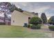 View of the side yard with a well-maintained lawn and neatly trimmed shrubbery at 12928 Sickles Dr, Charlotte, NC 28273