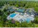 Beautiful aerial view of neighborhood swimming pool and tennis courts surrounded by trees at 142 Tuscany Trl, Mooresville, NC 28117