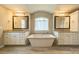 Luxurious bathroom featuring a soaking tub, double vanities, and stylish fixtures at 142 Tuscany Trl, Mooresville, NC 28117