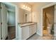 Elegant bathroom featuring double vanity with granite countertop and decorative lighting at 142 Tuscany Trl, Mooresville, NC 28117