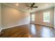 Spacious bedroom with hardwood floors, recessed lighting, and two windows offering ample natural light at 142 Tuscany Trl, Mooresville, NC 28117