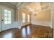 Formal dining room featuring hardwood floors, elegant trimwork, and decorative lighting fixture at 142 Tuscany Trl, Mooresville, NC 28117