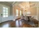 A dining room featuring a dining table set on an area rug in front of a bright window view at 142 Tuscany Trl, Mooresville, NC 28117