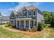 Charming two-story home with manicured lawn, professional landscaping and inviting front porch at 142 Tuscany Trl, Mooresville, NC 28117