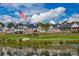 Beautiful lakeside community clubhouse with lush lawn and an American flag waving proudly at 142 Tuscany Trl, Mooresville, NC 28117