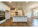 Bright kitchen with a large center island, pendant lighting, and sleek appliances at 142 Tuscany Trl, Mooresville, NC 28117