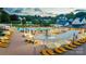 A luxurious outdoor pool area with many lounge chairs and umbrellas at dusk at 142 Tuscany Trl, Mooresville, NC 28117