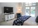 Bright bedroom featuring a pool view, soft lighting, and comfortable furnishings at 17048 Jetton Rd, Cornelius, NC 28031