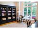 Cozy living room with built-in bookcase, patterned chairs, and natural light at 17048 Jetton Rd, Cornelius, NC 28031