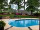 Backyard pool, landscaping, a patio set, fountain, and view of the golf course at 17048 Jetton Rd, Cornelius, NC 28031