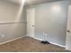 Neutral bedroom with carpet flooring, showcasing its spacious layout and multiple electrical outlets at 1707 Van Dyke Dr, Charlotte, NC 28213