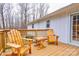 Relaxing back deck with a table and Adirondack chairs for enjoying the scenery and outdoor living at 1925 S Lafayette St, Shelby, NC 28152