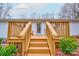 Inviting back deck with wooden steps and railing, perfect for outdoor relaxation and enjoying the surroundings at 1925 S Lafayette St, Shelby, NC 28152