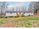 Expansive backyard featuring a spacious white house and a wooden deck for outdoor enjoyment at 1925 S Lafayette St, Shelby, NC 28152