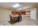 Finished basement area with a wooden dining table, bar top, and shelving at 1925 S Lafayette St, Shelby, NC 28152