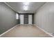 Spacious basement with neutral walls, flooring, and white double door closets at 1925 S Lafayette St, Shelby, NC 28152