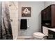 Cozy bathroom features a tiled shower, modern vanity, and a stylish barn-themed wall decor at 1925 S Lafayette St, Shelby, NC 28152