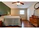 Bedroom featuring wood-look floors, a ceiling fan, and neutral color scheme at 1925 S Lafayette St, Shelby, NC 28152