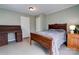 Well-lit bedroom includes a large bed, vintage desk, and relaxing green tones at 1925 S Lafayette St, Shelby, NC 28152