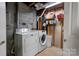 Basement laundry room featuring a washing machine, dryer, and shelving at 1925 S Lafayette St, Shelby, NC 28152