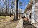 Side view of house showing backyard with deck, mature trees, and well-maintained lawn at 1937 Hickory Dr, Lancaster, SC 29720