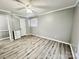 Bedroom with neutral walls, laminate floors, closet and view into Primary bathroom at 1937 Hickory Dr, Lancaster, SC 29720