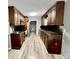 Galley kitchen featuring dark wood cabinetry and modern appliances at 1937 Hickory Dr, Lancaster, SC 29720