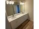 Bathroom featuring a double sink vanity with a large mirror and ample lighting at 1941 Olsen Ln, Charlotte, NC 28213