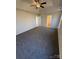 Large bedroom featuring neutral walls, tray ceiling with fan, and soft gray carpeting at 1941 Olsen Ln, Charlotte, NC 28213