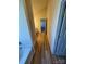 Hallway with wood floors leading to a bathroom featuring a tub and vanity at 1941 Olsen Ln, Charlotte, NC 28213