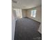 Spacious living room with gray carpet and natural light from large windows at 1941 Olsen Ln, Charlotte, NC 28213