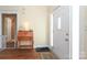 Welcoming entrance hall with wood floors, a white front door, and a table with a lamp, creating a warm ambiance at 2003 Hemby Commons Pkwy, Indian Trail, NC 28079