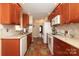 Galley kitchen features wood cabinets, neutral countertops and backsplash, and decorative flooring at 2003 Hemby Commons Pkwy, Indian Trail, NC 28079