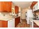 Galley kitchen features wood cabinets, neutral countertops and backsplash, and decorative flooring at 2003 Hemby Commons Pkwy, Indian Trail, NC 28079