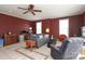 Living room with neutral carpet, burgundy walls, ceiling fan, and lots of natural light at 2003 Hemby Commons Pkwy, Indian Trail, NC 28079