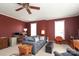 Living room with neutral carpet, burgundy walls, ceiling fan, and lots of natural light at 2003 Hemby Commons Pkwy, Indian Trail, NC 28079