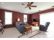 Living room with neutral carpet, burgundy walls, ceiling fan, and lots of natural light at 2003 Hemby Commons Pkwy, Indian Trail, NC 28079