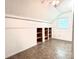 Attic space featuring built-in wooden shelving and a window bringing in natural light at 2025 Sojourn Rd, Marshville, NC 28103